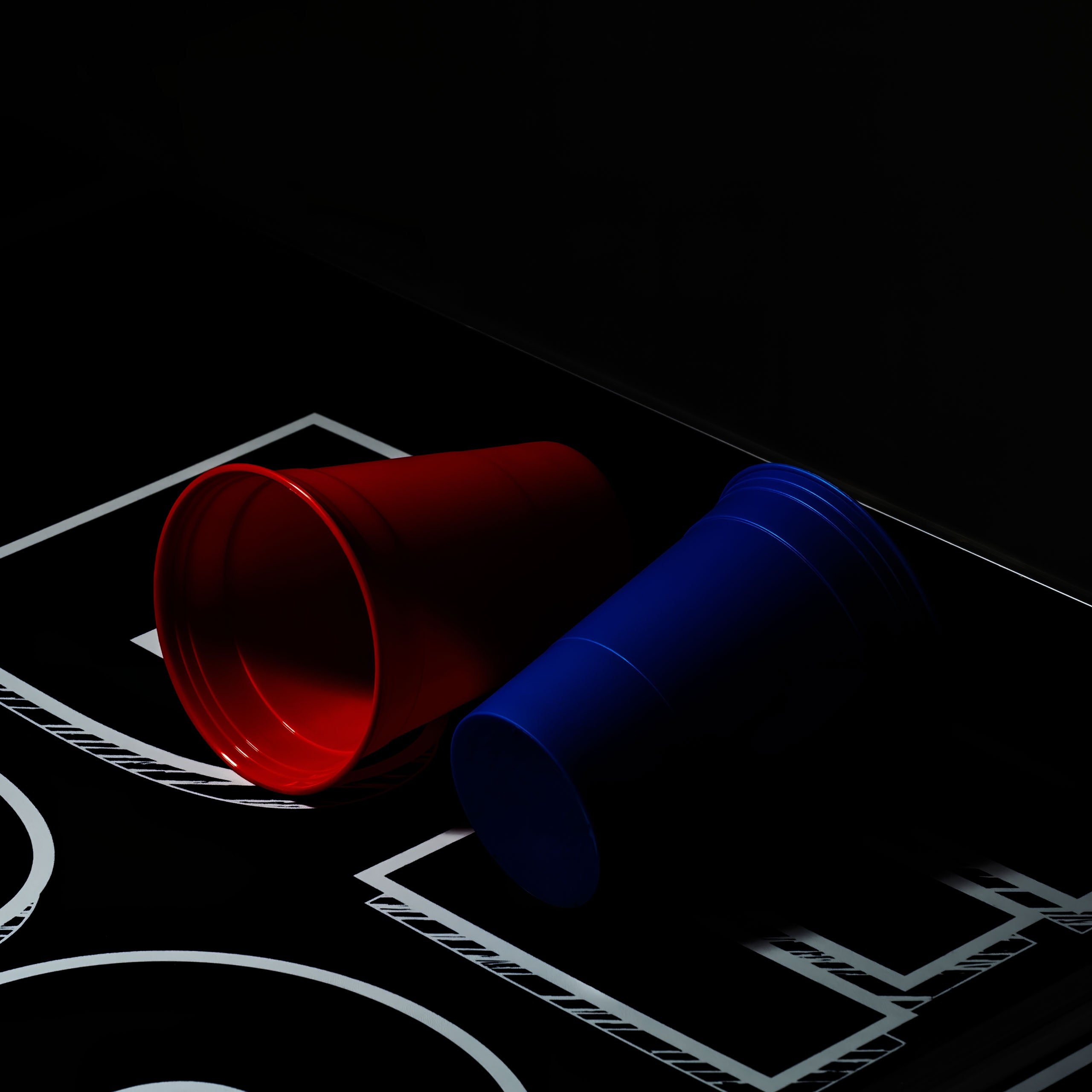 Ein einzelner roter und blauer Beerpong Becher auf einem Bierpong Tisch liegend